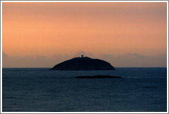 Island with lighthouse at sunrise, viewed from Ipanema.