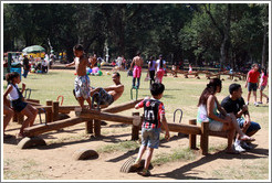 People playing on seesaws.  Parque do Ibirapuera.