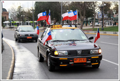 Taxi with eight Chilean flags.