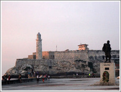 Morro Castle (Castillo de los Tres Reyes del Morro) with a statue of Miranda at dusk.