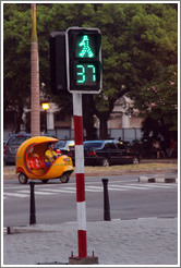 Walk sign with a countdown of remaining seconds, and a Coco taxi, Paseo del Prado.