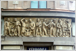 Nine laborers, with the caption "EXPORT IMPORT" carved into a building on Pansk?Nov?&#283;sto.