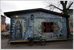 House painted with a strong female figure and "To exist is to Resist".
