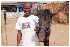 Employee of the Gambia Horse & Donkey Trust with horse named Lazarus.