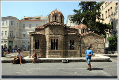 Man blowing bubbles in front of the Church of Panaghia Kapnikarea (&#917;&#954;&#954;&#955;&#951;&#963;&#943;&#945; &#964;&#951;&#962; &#928;&#945;&#957;&#945;&#947;&#943;&#945;&#962; &#922;&#945;&#960;&#957;&#953;&#954;&#945;&#961;&#941;&#945;&#962;), one of the oldest churches in Athens.