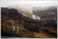 Geothermal steam rising from the ground.