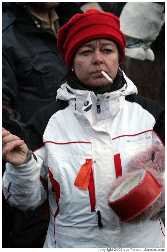 Reykjavik protest.  Smoking woman banging a pot.