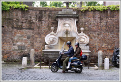 Scooter riders in front of Fontana del Mascherone (Fountain of the Mask) (1626).