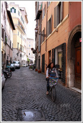 Woman riding bicycle on Via del Pellegrino.