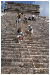 People sliding down on their butts from the pyramid.  Chichen Itza.