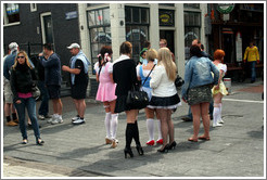 Women dressed in schoolgirl clothes, corner of Prins Hendrikkade and Nieuwendijk, Centrum district.